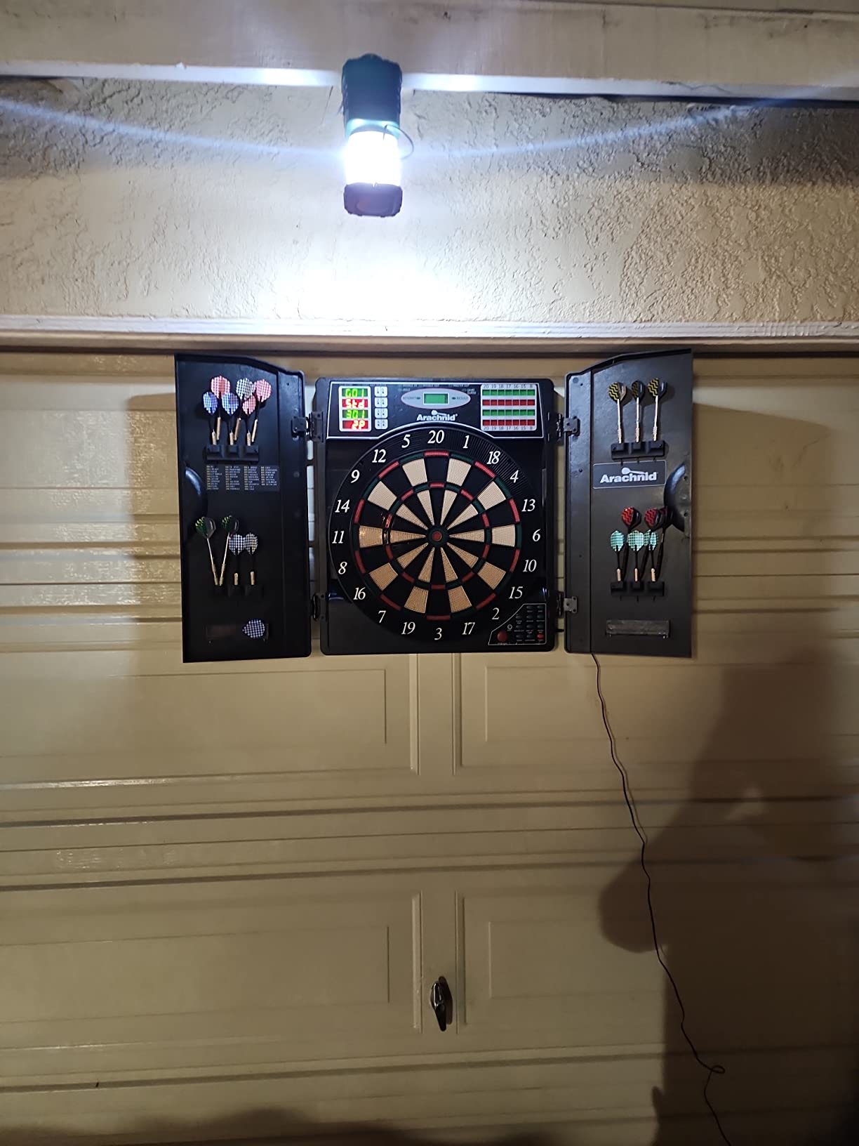 Arachnid Titanium 5400: 13.5” Target with Integrated Cabinet. Offers 38 Games, 316 Variations, Color LED Scoring, and Solo Play. Includes Double in/Out Modes for Competitive Game Room Fun. customer photo 1