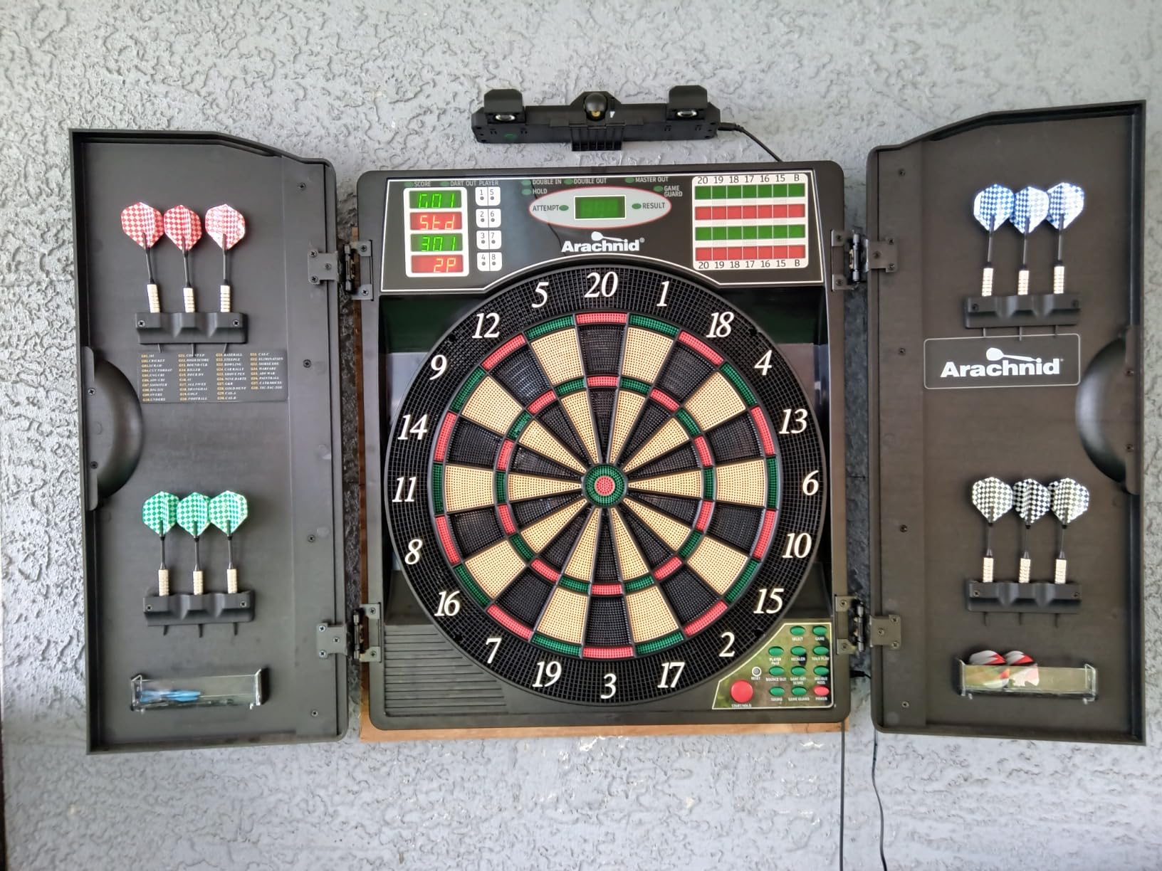 Arachnid Titanium 5400: 13.5” Target with Integrated Cabinet. Offers 38 Games, 316 Variations, Color LED Scoring, and Solo Play. Includes Double in/Out Modes for Competitive Game Room Fun. customer photo 2